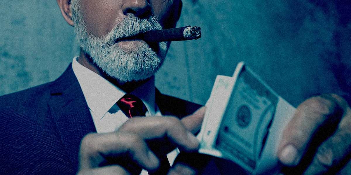 Close up of a man in suit, smoking a cigar and counting a stack of money